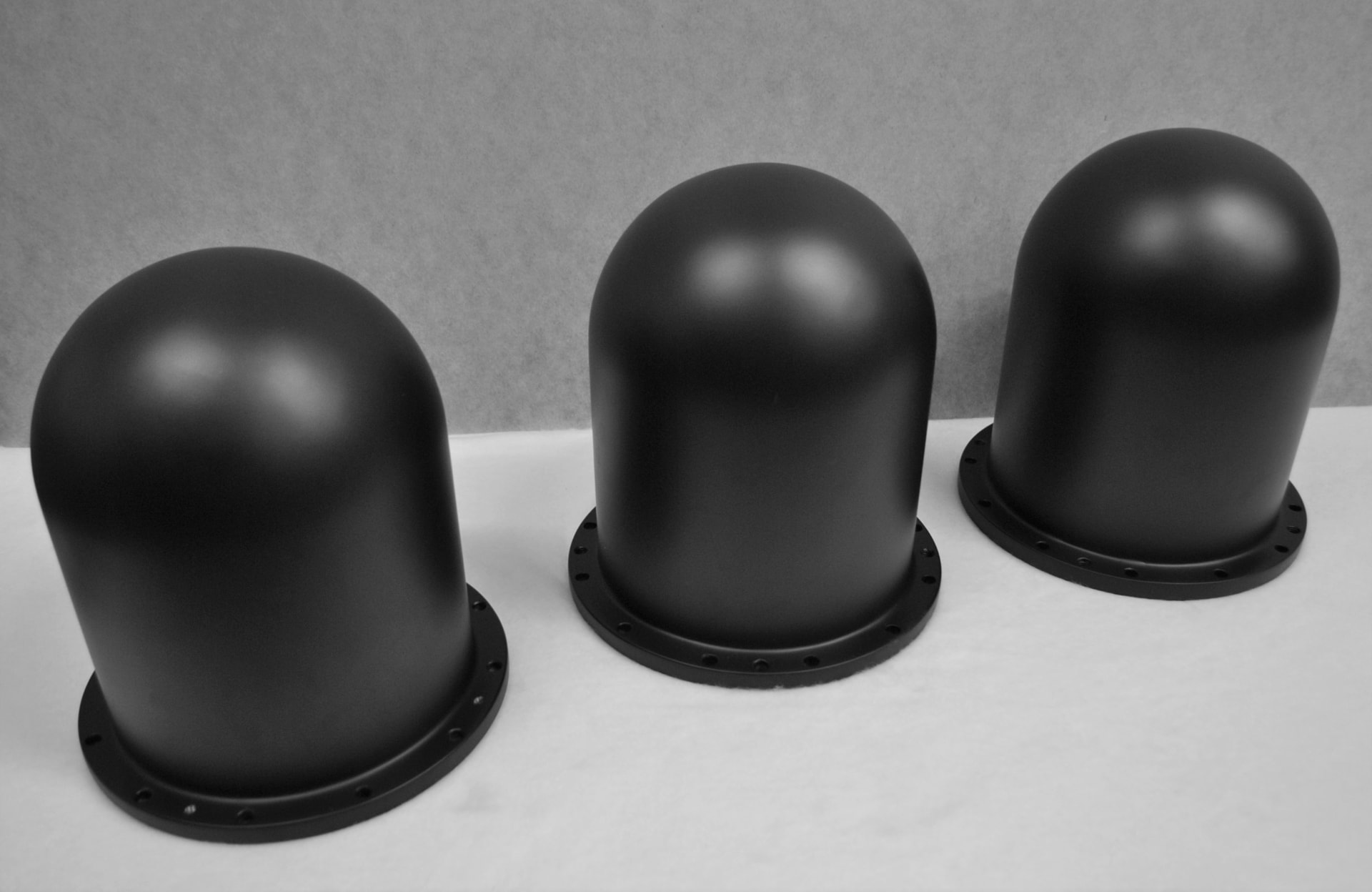 Three composite radomes finished in matt black