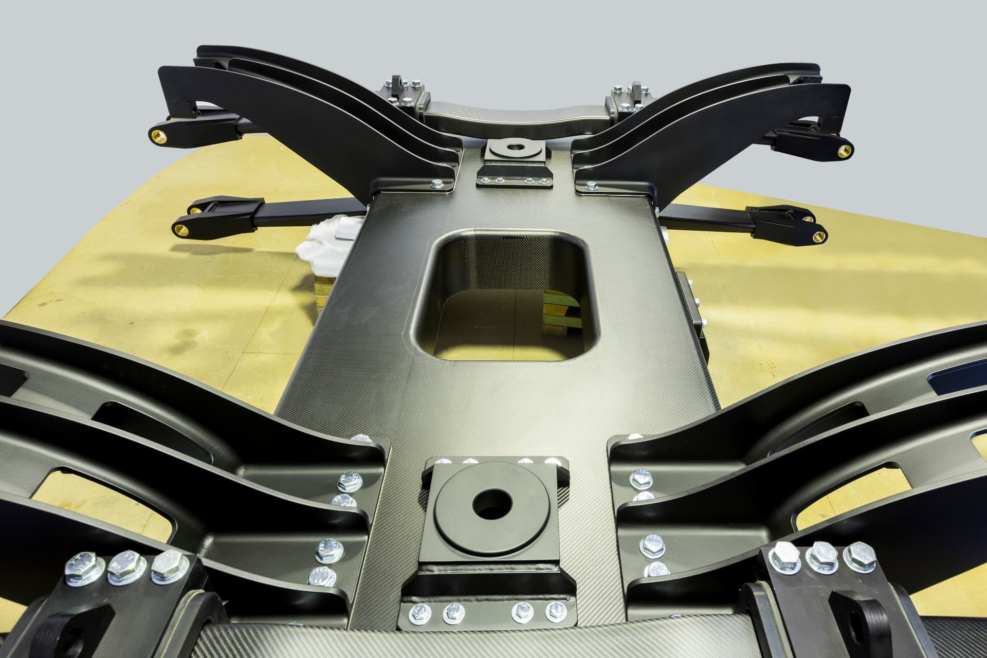 Precision carbon fibre chassis structure with machined alloy fittings