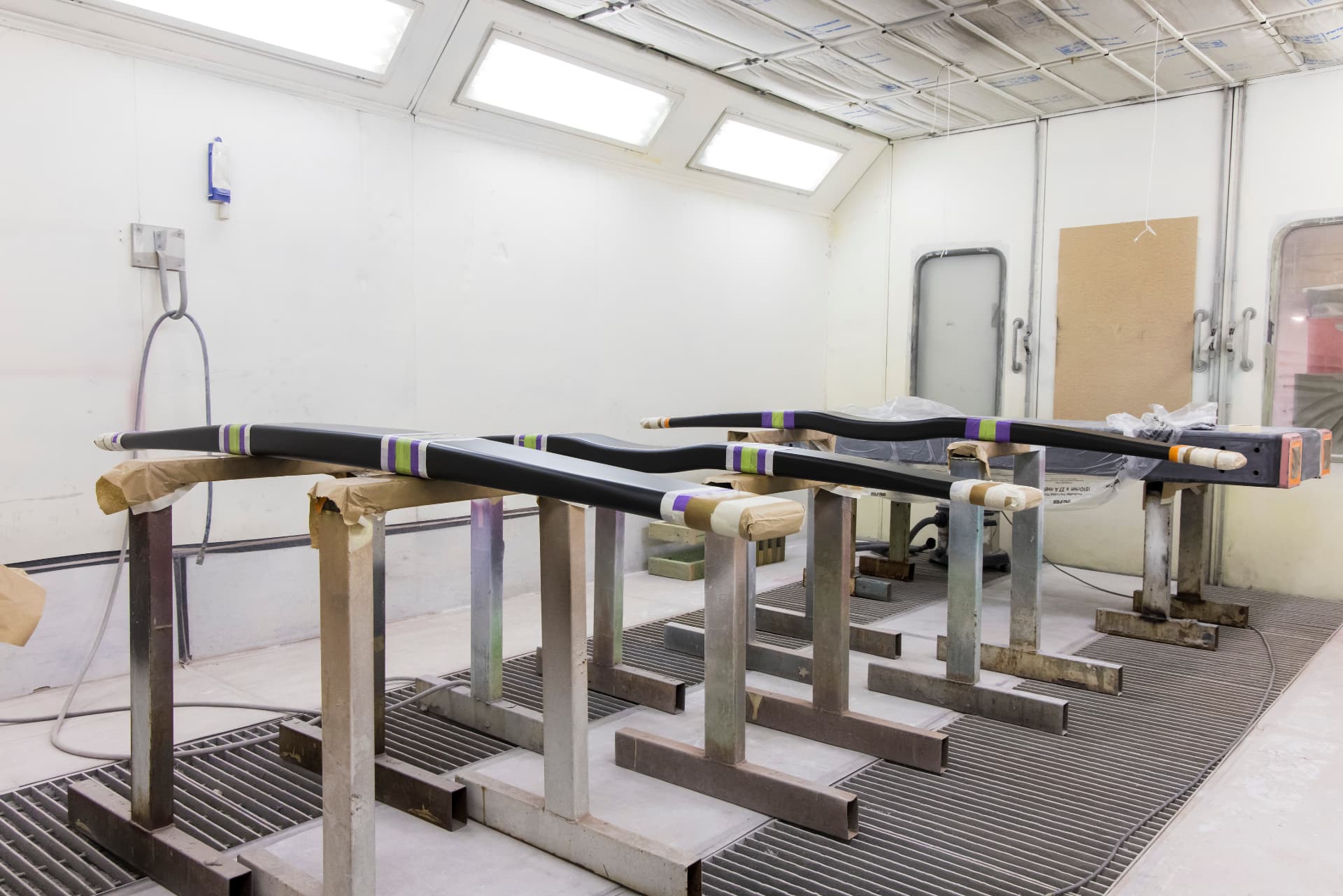 Carbon composite foil arms in the paint booth during finishing