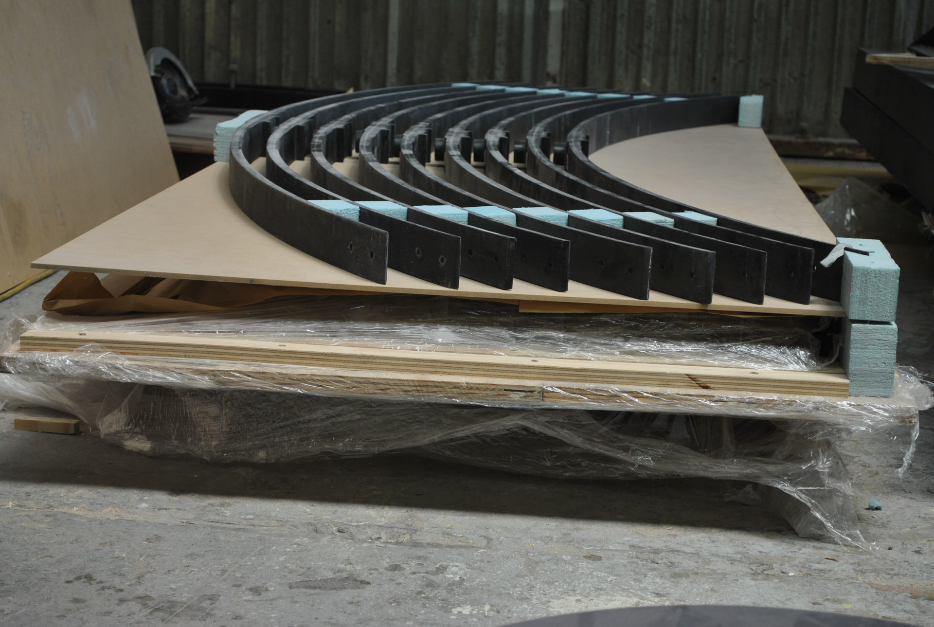 Pre-cut carbon fibre ring frames stacked and packed ready for assembly