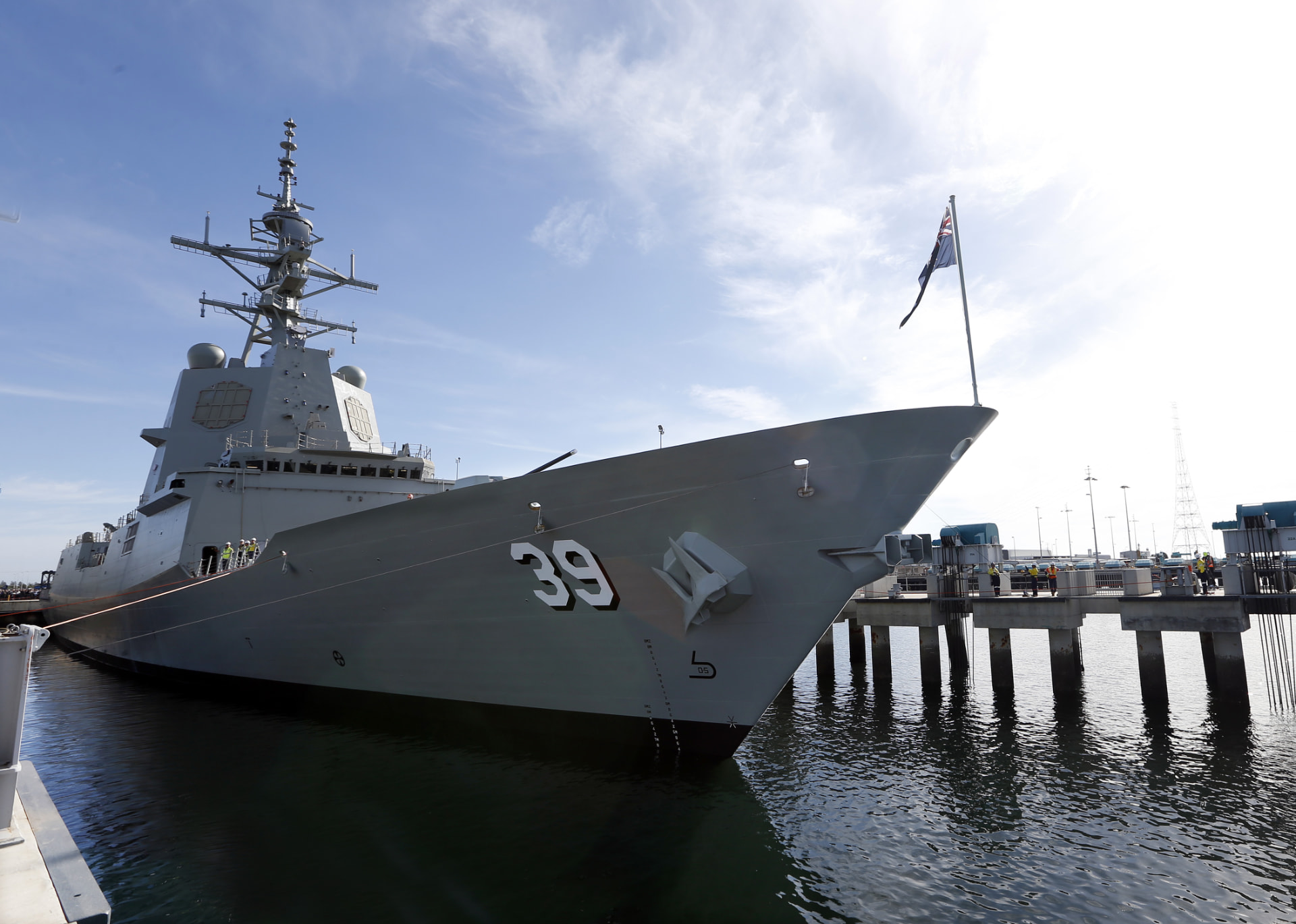 Royal Australian Navy destroyer alongside the wharf under a clear sky